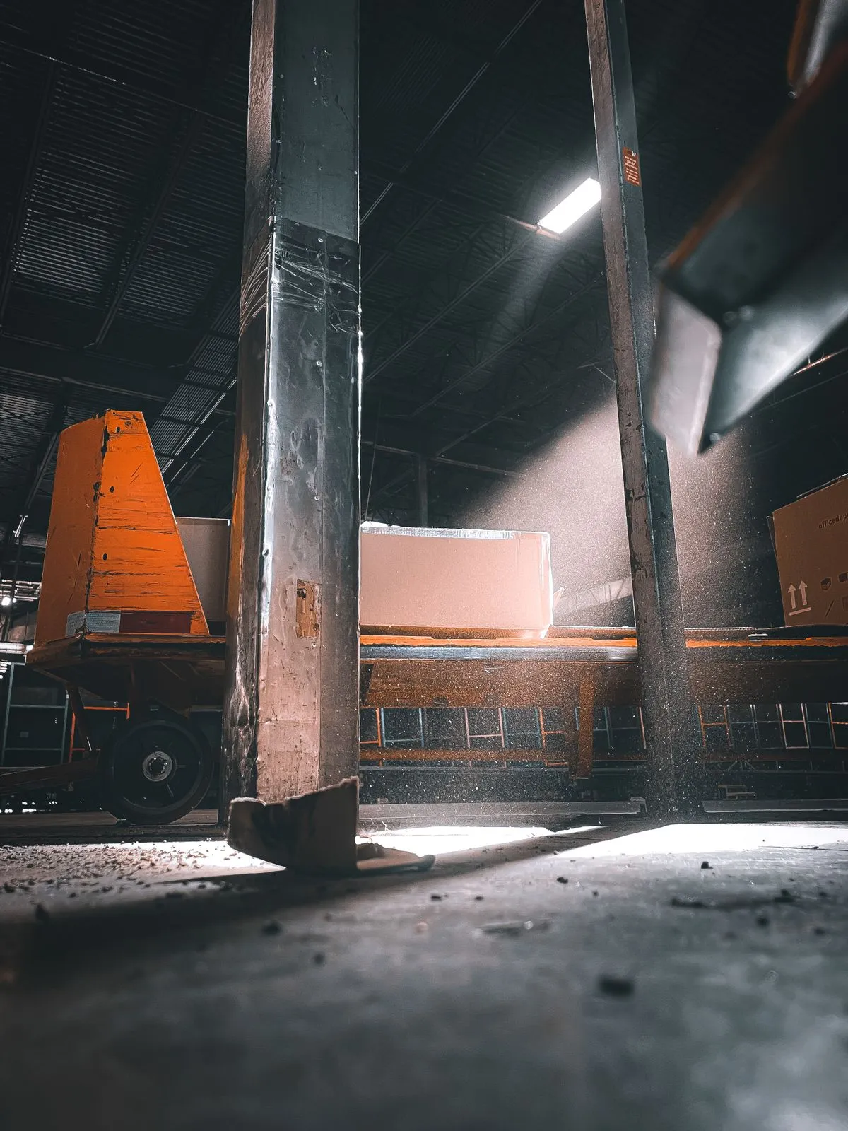 Overhead crane moving heavy equipment in a warehouse